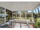 Enclosed patio with a view of the backyard and comfortable outdoor seating area at 6738 Brentford Rd, Sarasota, FL 34241