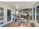 Cozy screened patio with seating, accessible from the house via glass doors, with view of backyard at 6738 Brentford Rd, Sarasota, FL 34241