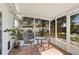 Cozy screened patio with outdoor furniture, grill, and view of the backyard at 6738 Brentford Rd, Sarasota, FL 34241