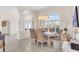 Formal dining room with large windows and elegant chandelier at 6780 Pan American Blvd, North Port, FL 34287