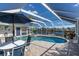 Enjoy this screened pool and spa with a patio table at 6780 Pan American Blvd, North Port, FL 34287