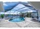 Screened-in pool and spa with canal views at 6780 Pan American Blvd, North Port, FL 34287