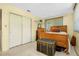 Cozy bedroom with wood-framed bed, ample closet space, and neutral color palette at 9027 E River Rd, Venice, FL 34293