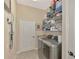 Well-equipped laundry room with washer, dryer, and ample storage shelving at 1062 Eagles Flight Way, North Port, FL 34287