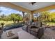 Relaxing screened patio with wicker furniture and view of backyard at 110 Palazzo Ct, North Venice, FL 34275