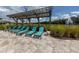 Relaxing lounge chairs under a shaded pergola by the pool at 12586 Oak Hill Way, Parrish, FL 34219