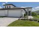 Modern two-car garage house with walkway and landscaping at 12586 Oak Hill Way, Parrish, FL 34219