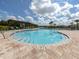 Community pool with a pergola and plenty of lounge chairs at 12586 Oak Hill Way, Parrish, FL 34219