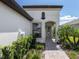 Inviting entryway with a walkway and lush landscaping at 12586 Oak Hill Way, Parrish, FL 34219