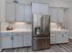 Modern kitchen with stainless steel appliances and gray cabinets at 12586 Oak Hill Way, Parrish, FL 34219