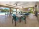 Covered patio area with tables and chairs overlooking the pool at 12586 Oak Hill Way, Parrish, FL 34219