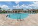 Inviting freeform pool with plenty of lounge chairs and a pool house at 12586 Oak Hill Way, Parrish, FL 34219