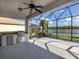 Screened patio with built-in grill and lake view at 126 Cipriani Way, North Venice, FL 34275
