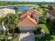 Single-Gathering home with tile roof and attached garage; water view at 126 Cipriani Way, North Venice, FL 34275