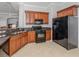 Modern kitchen with dark wood cabinets and granite countertops at 126 Cipriani Way, North Venice, FL 34275