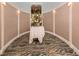 Elegant hallway with a floral centerpiece and unique wall design at 126 Cipriani Way, North Venice, FL 34275