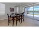 Bright dining room with sliding glass doors leading to a scenic patio and golf course view at 126 Cipriani Way, North Venice, FL 34275