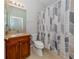 Clean bathroom with shower/tub and wood vanity at 126 Cipriani Way, North Venice, FL 34275