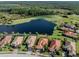 Aerial view of a house near a lake and golf course at 126 Cipriani Way, North Venice, FL 34275