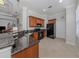 Open kitchen with granite countertops and stainless steel appliances at 126 Cipriani Way, North Venice, FL 34275