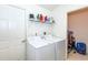 Laundry room with washer, dryer, and storage at 4195 Fairway Pl, North Port, FL 34287
