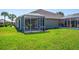 Backyard with screened patio and lush grass at 4195 Fairway Pl, North Port, FL 34287