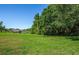 Grass lot with pond and tree line in background at 4195 Fairway Pl, North Port, FL 34287