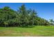 Large grassy lot with mature trees at 4195 Fairway Pl, North Port, FL 34287