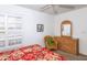 Bedroom with wicker furniture and red floral bedding at 4195 Fairway Pl, North Port, FL 34287