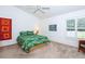 Bright bedroom with a tropical-themed bed and window shutters at 4195 Fairway Pl, North Port, FL 34287