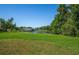 Green grassy lot with pond and trees at 4195 Fairway Pl, North Port, FL 34287