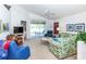 Spacious living room featuring a ceiling fan, comfy seating, and view of patio at 4195 Fairway Pl, North Port, FL 34287