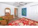 Bright bedroom with a dresser, chair, and floral bedding at 4195 Fairway Pl, North Port, FL 34287