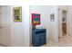Entryway with blue cabinet, mirror, and artwork at 4195 Fairway Pl, North Port, FL 34287