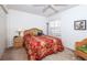 Bedroom with a double bed, nightstand, and wicker furniture at 4195 Fairway Pl, North Port, FL 34287