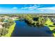Community view with lake, homes, and lush landscape at 4195 Fairway Pl, North Port, FL 34287