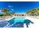 Relaxing community pool with lounge chairs and palm trees at 4195 Fairway Pl, North Port, FL 34287