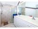 Bathroom with double vanity, shower, and whimsical decor at 4195 Fairway Pl, North Port, FL 34287