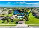 Community pool and clubhouse with lush landscaping at 4195 Fairway Pl, North Port, FL 34287
