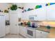 White kitchen with stainless steel appliances and corner pantry at 4195 Fairway Pl, North Port, FL 34287