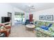 Spacious living room featuring a ceiling fan, comfy seating, and view of patio at 4195 Fairway Pl, North Port, FL 34287