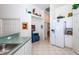 Kitchen with white cabinets, green countertops, and a large refrigerator at 4195 Fairway Pl, North Port, FL 34287