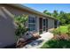 House exterior showcasing a walkway, landscaping, and screened patio at 4195 Fairway Pl, North Port, FL 34287