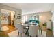 Casual dining area with a round table and six chairs, open to kitchen at 2480 Alamander Ave, Englewood, FL 34223