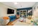 Bright living room features comfortable seating and a view of the backyard at 2480 Alamander Ave, Englewood, FL 34223