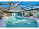 Inviting, screened pool area with patio furniture at 2480 Alamander Ave, Englewood, FL 34223