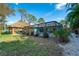 Inviting pool area with tiki hut and fenced yard at 2480 Alamander Ave, Englewood, FL 34223