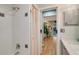 Well-lit bathroom with a shower/tub combo and linen closet at 2480 Alamander Ave, Englewood, FL 34223