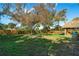 Large backyard with a putting green and mature oak tree at 2480 Alamander Ave, Englewood, FL 34223