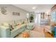 Open living room with a light teal sectional sofa at 2480 Alamander Ave, Englewood, FL 34223